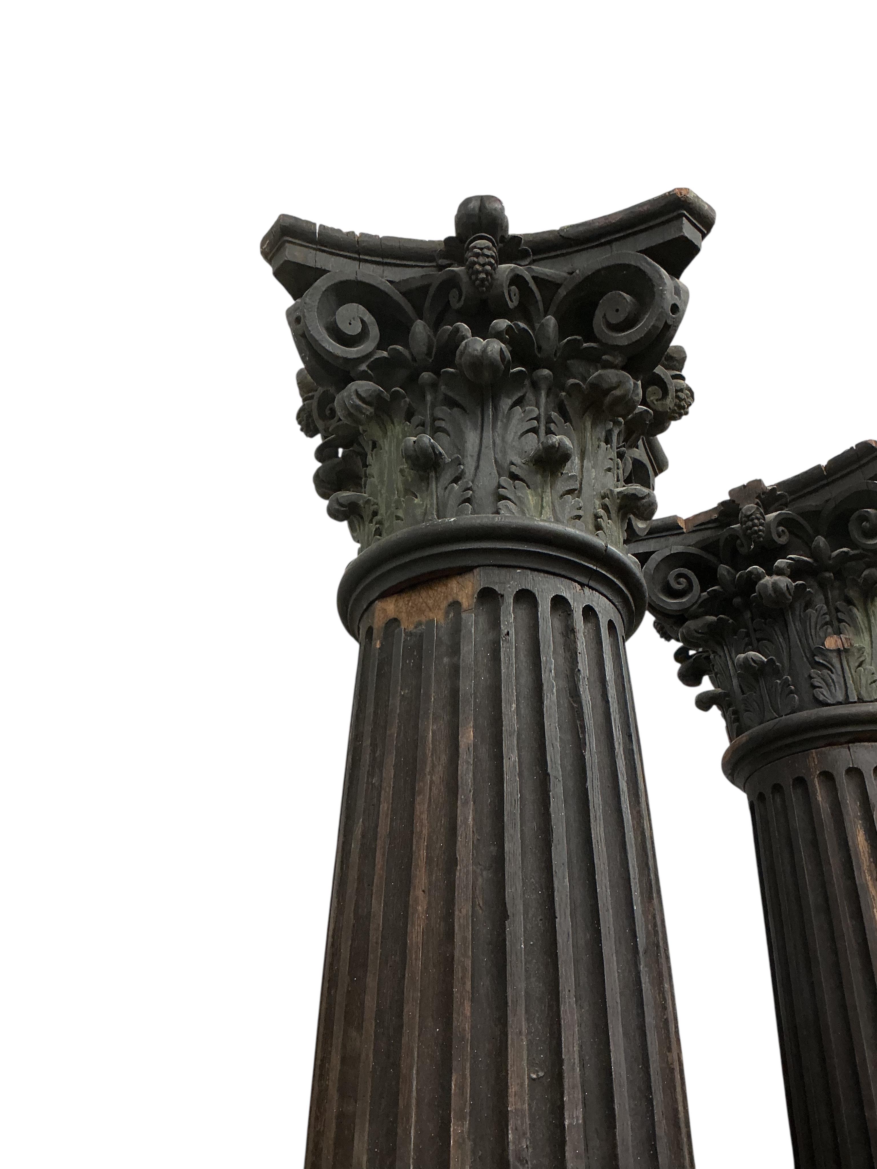 A pair of 17th century oak Corinthian columns, of large size, height 279cm, by repute from St Mary le Bow, designed by Christopher Wren
